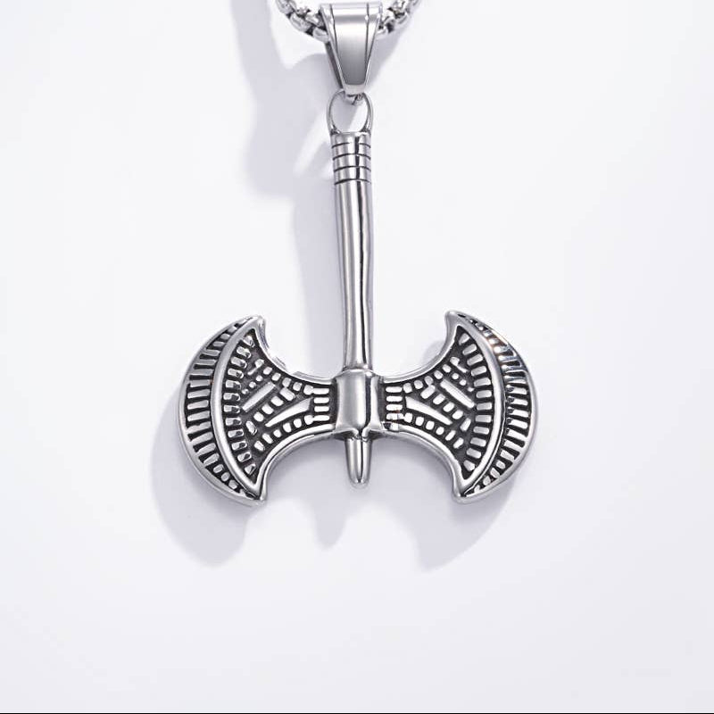A silver-toned metal pendant necklace featuring a detailed double-headed axe or athame design on a matching box chain, shown against a plain white background.